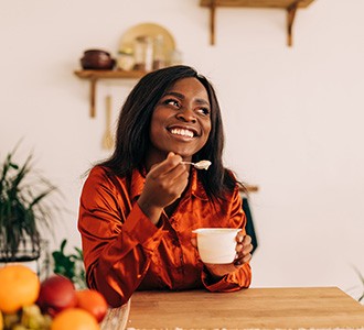 Woman eating a cup of yogurt