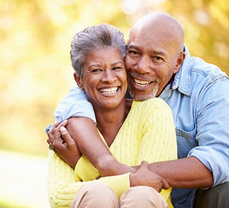 Couple showing off their dental implants