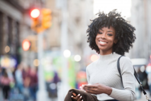 Woman smiling and enjoying the city with her new dental cosmetics